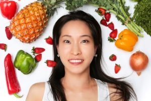 Fumi Somehara is surrounded by fruit and vegetables
